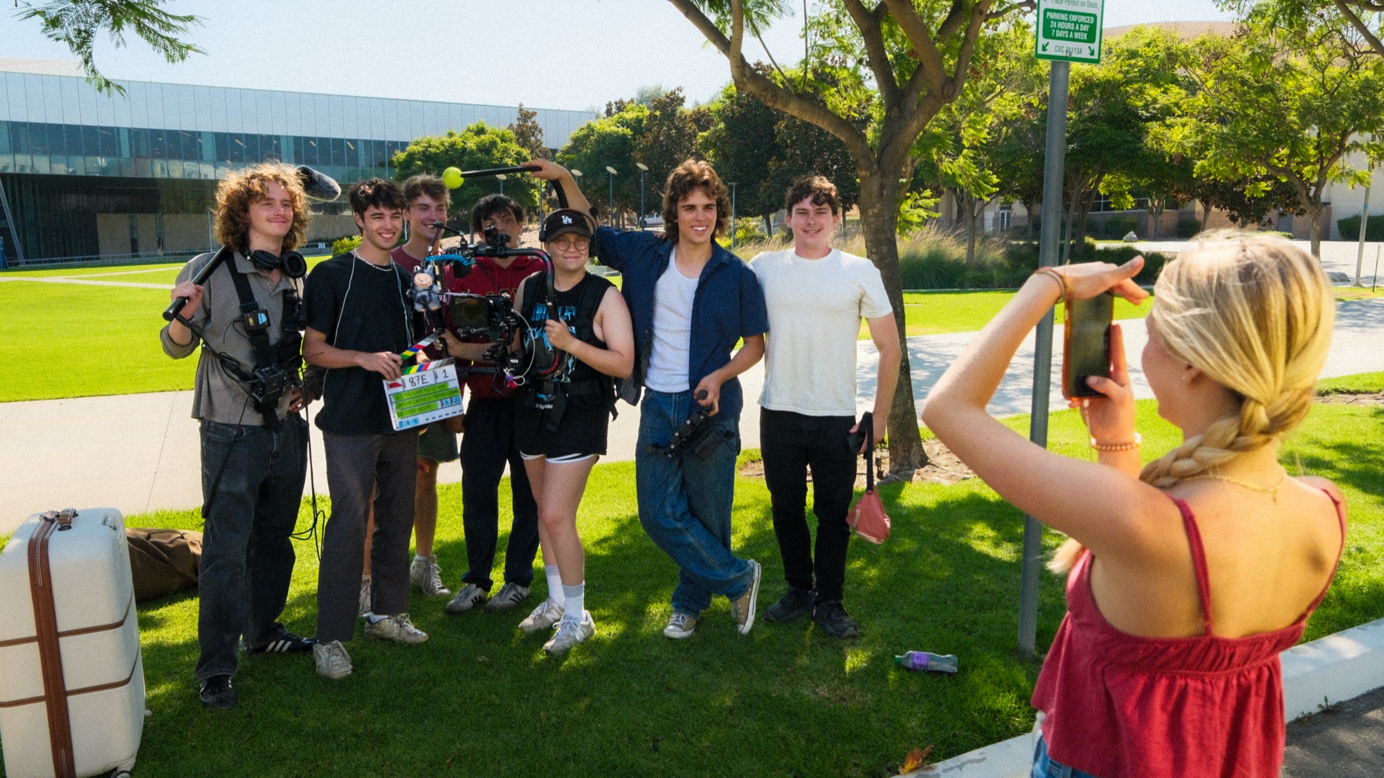 The cast and crew posing together after a daytime shoot